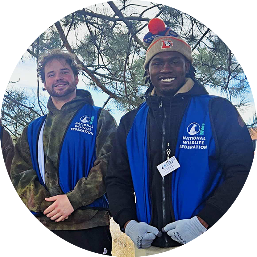 Two smiling people wearing blue National Wildlife Federation vests