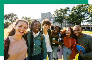 Group of young people standing together outdoors and smiling 
