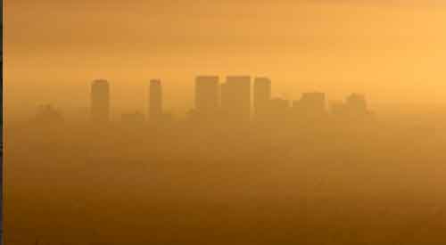 Hazy orange sky with city skyline