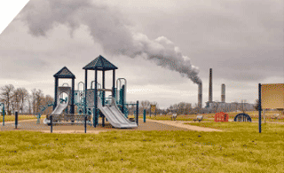 Playground with smokestack in the background