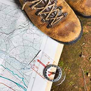 Hiking boot with map and compass