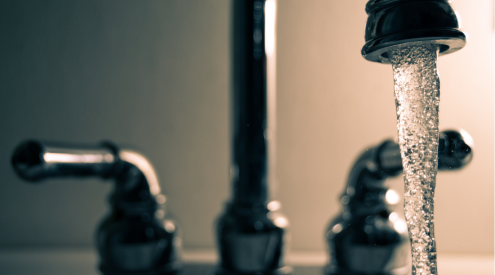 A faucet with tap water flowing 