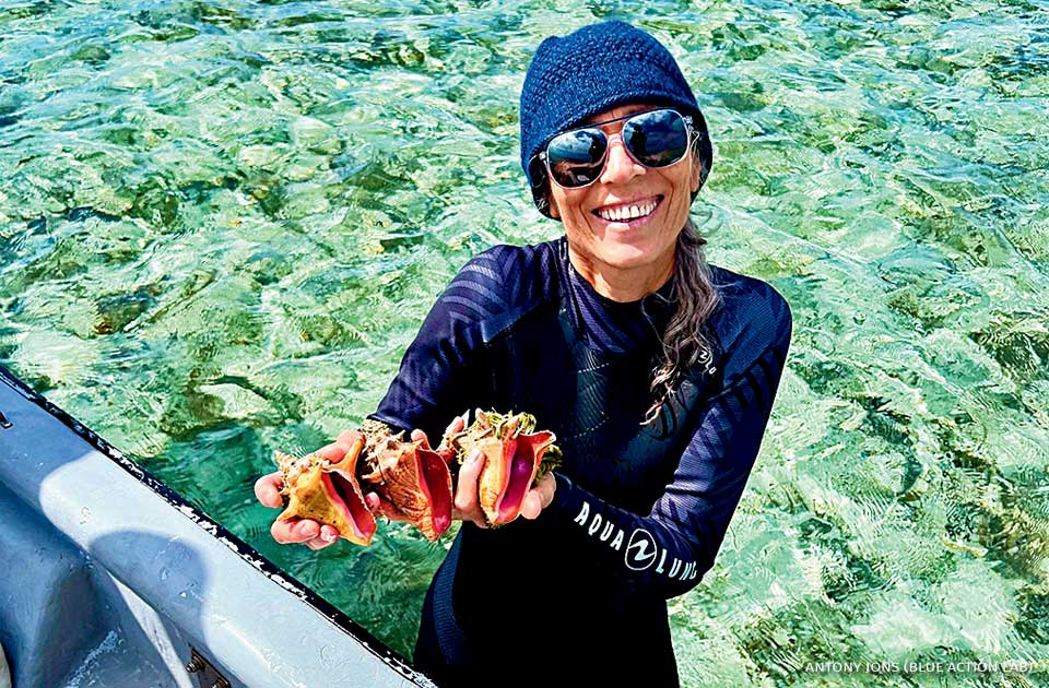 An image of Megan Davis at a queen conch nursery.