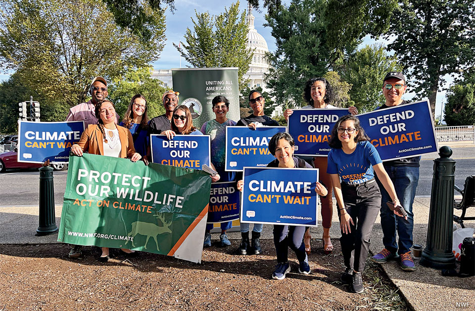 An image of people with signs supporting climate action.